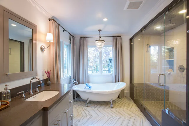 Modern bathroom with a vanity, free-standing bathtub, and glass-enclosed shower designed by Bathroom Remodel Company San Francisco, Front Street Builders