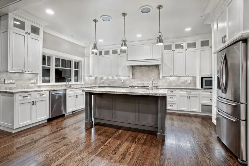 Spacious modern kitchen with white cabinets, a grey central island, and stainless steel appliances designed by Kitchen Renovation Company San Francisco, Front Street Builders